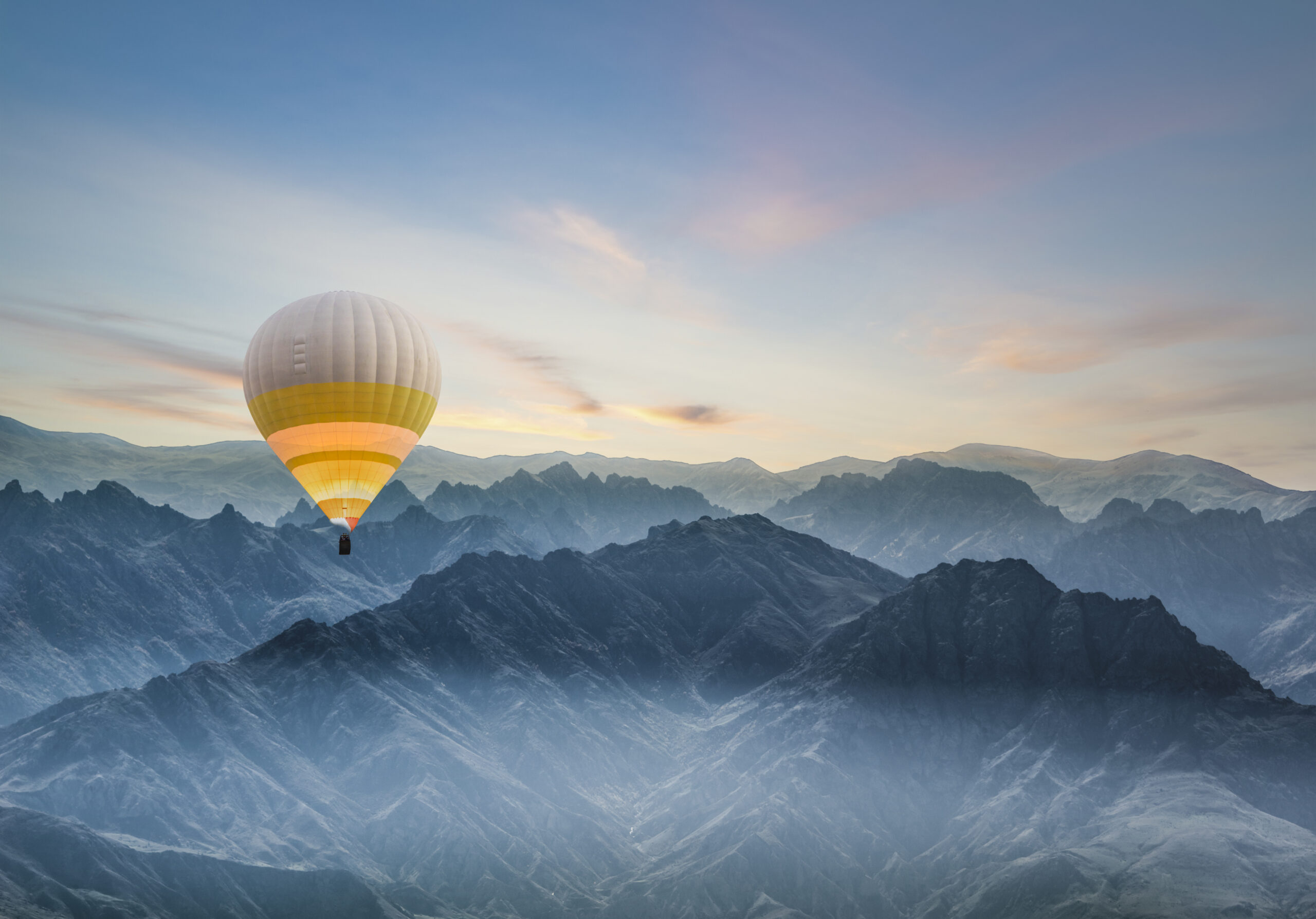Hot air balloon flying over rocky mountains in TURKEY
